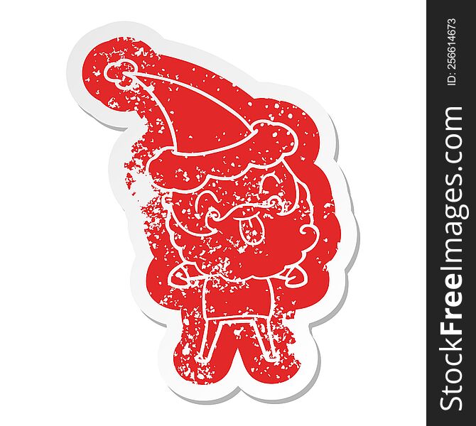 distressed sticker of man with beard sticking out tongue wearing santa hat