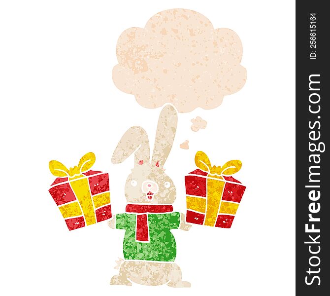 cartoon rabbit with christmas presents with thought bubble in grunge distressed retro textured style. cartoon rabbit with christmas presents with thought bubble in grunge distressed retro textured style