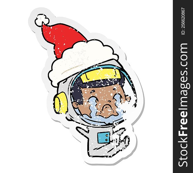 Distressed Sticker Cartoon Of A Crying Astronaut Wearing Santa Hat