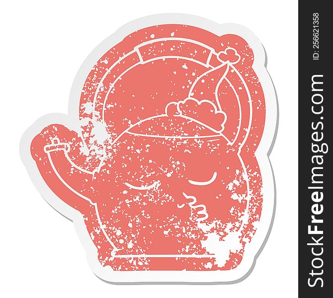 quirky cartoon distressed sticker of a kettle wearing santa hat