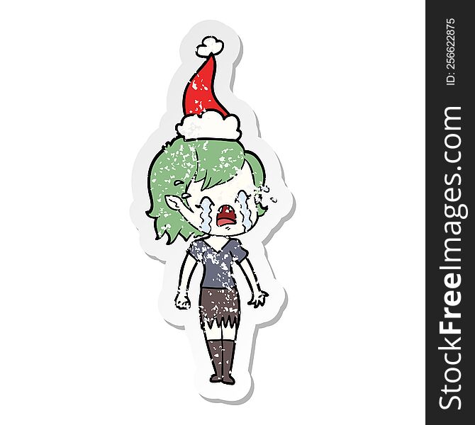 Distressed Sticker Cartoon Of A Crying Vampire Girl Wearing Santa Hat
