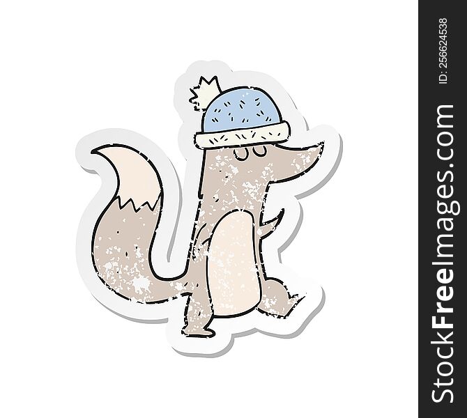 Retro Distressed Sticker Of A Cartoon Little Wolf Wearing Hat