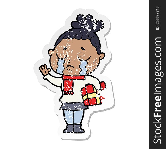 distressed sticker of a cartoon crying woman with christmas gift