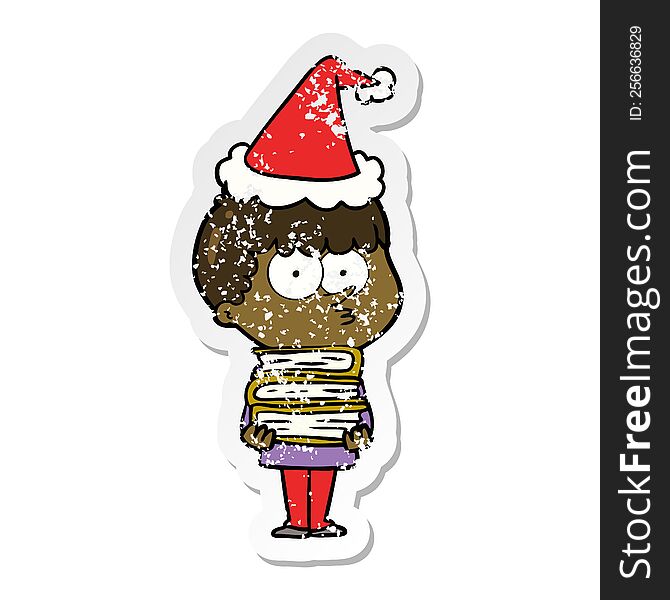 distressed sticker cartoon of a curious boy with lots of books wearing santa hat
