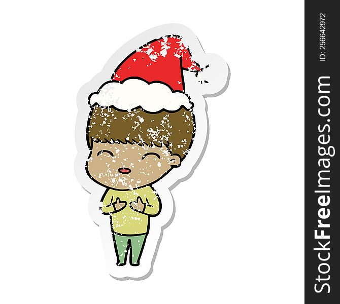 Happy Distressed Sticker Cartoon Of A Boy Wearing Santa Hat