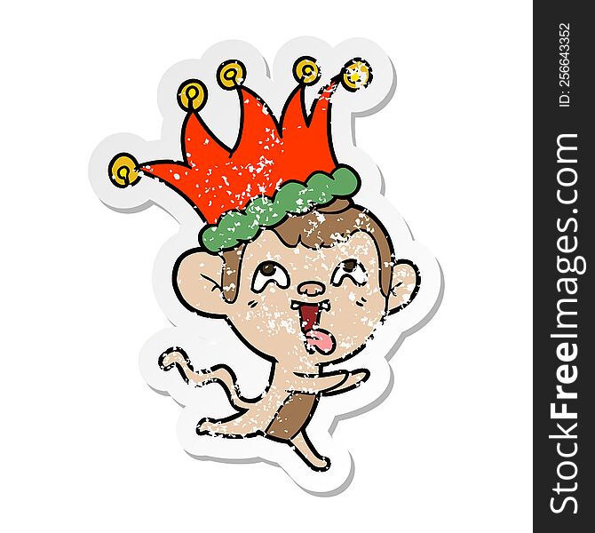 Distressed Sticker Of A Crazy Cartoon Monkey Wearing Jester Hat