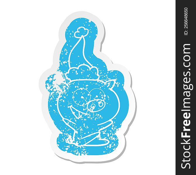cheerful sitting pig quirky cartoon distressed sticker of a wearing santa hat