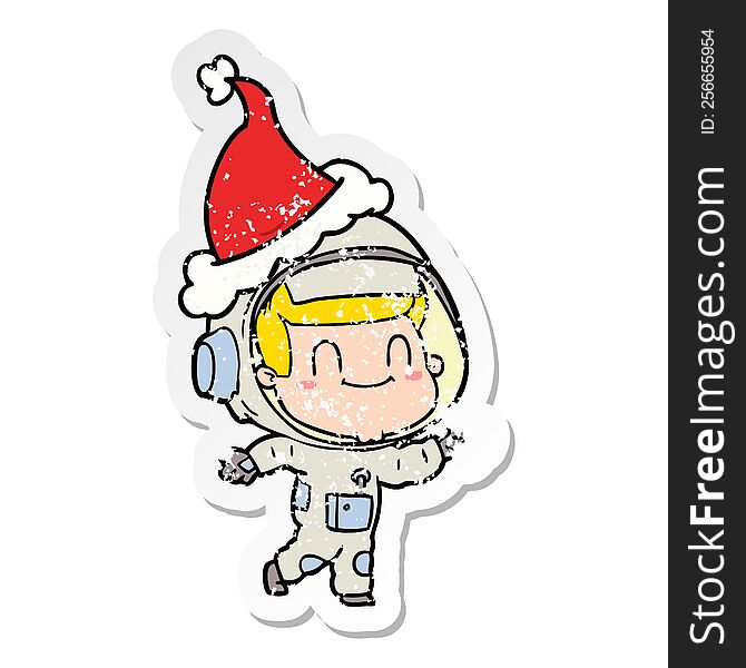 Happy Distressed Sticker Cartoon Of A Astronaut Man Wearing Santa Hat