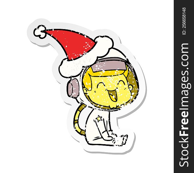 happy hand drawn distressed sticker cartoon of a astronaut wearing santa hat
