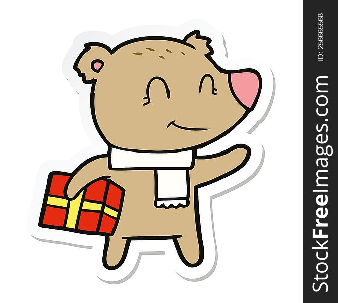 sticker of a friendly bear with xmas gift and scarf