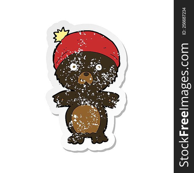 Retro Distressed Sticker Of A Cartoon Cute Black Bear In Hat