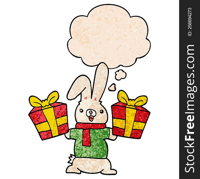 cartoon rabbit with christmas presents with thought bubble in grunge texture style. cartoon rabbit with christmas presents with thought bubble in grunge texture style
