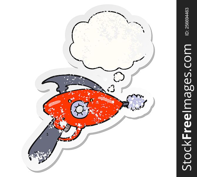 cartoon ray gun with thought bubble as a distressed worn sticker