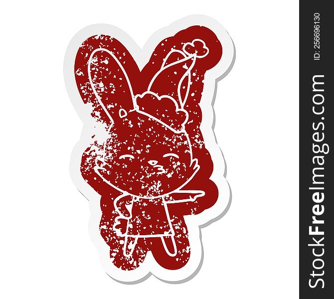 curious bunny quirky cartoon distressed sticker of a wearing santa hat