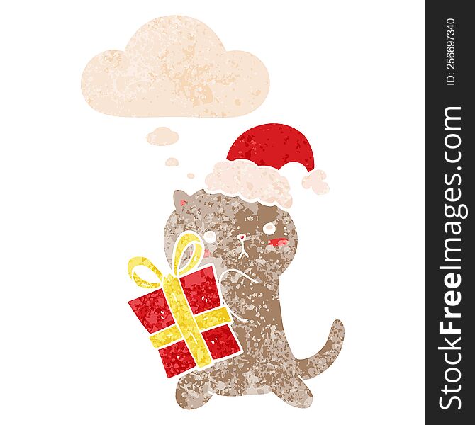 cute cartoon cat carrying christmas present and thought bubble in retro textured style