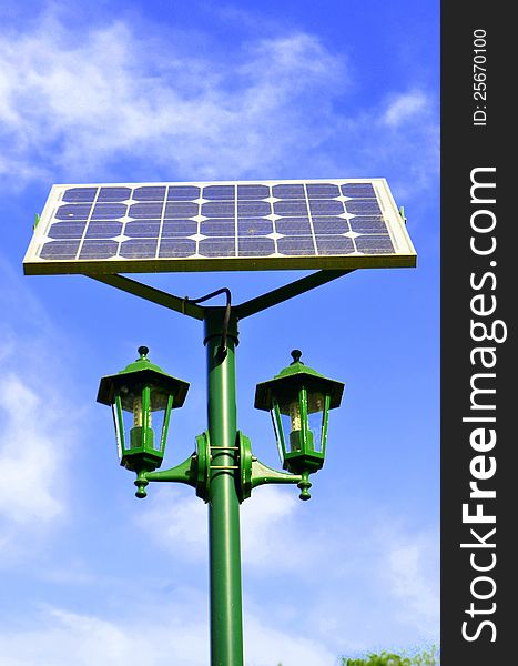 Image of a solar panel giving power to a park lamp