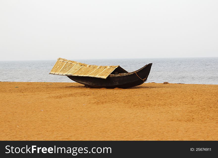 Wooden fishing boat on sandy beach