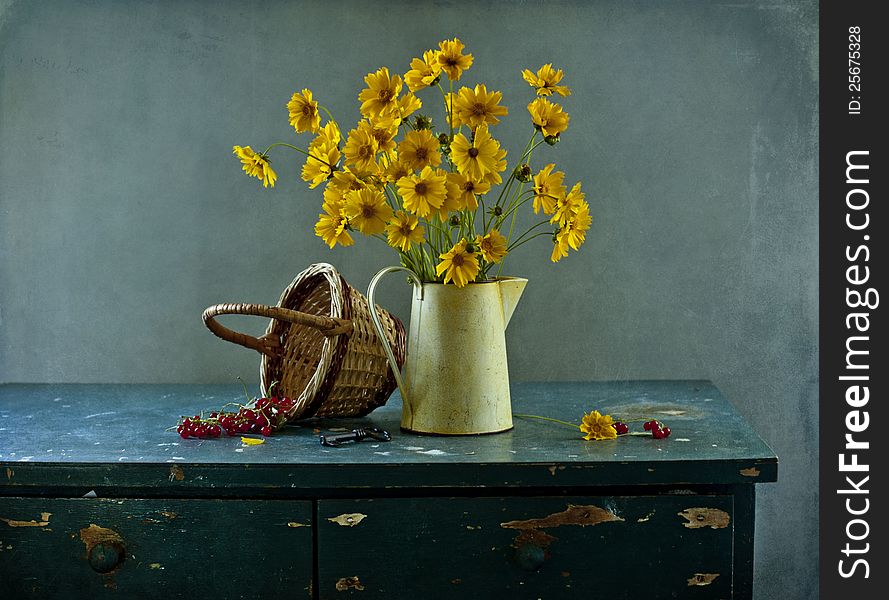 Still life with yellow flowers and red currant