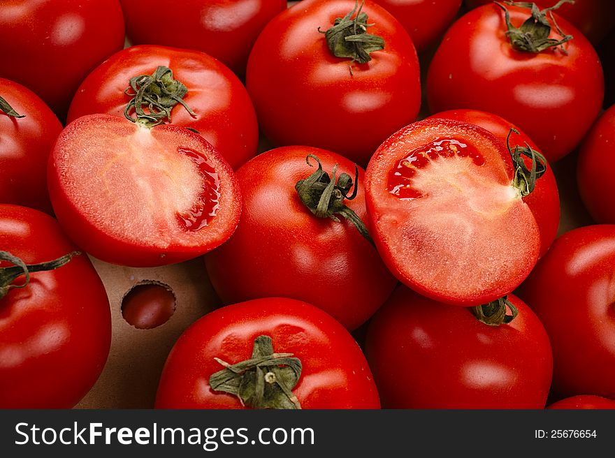 Tasty tomatoes in a box  on white. Tasty tomatoes in a box  on white