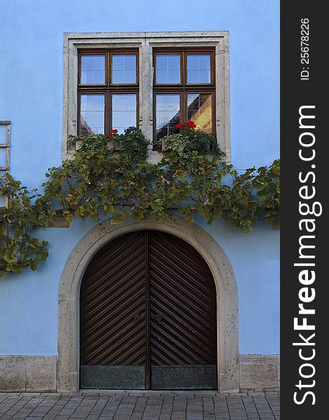 Shuttered windows with trellis of vines above and on the sides of a German house. Shuttered windows with trellis of vines above and on the sides of a German house.