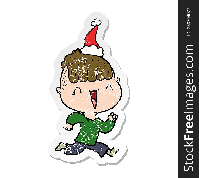 hand drawn distressed sticker cartoon of a happy boy surprised wearing santa hat