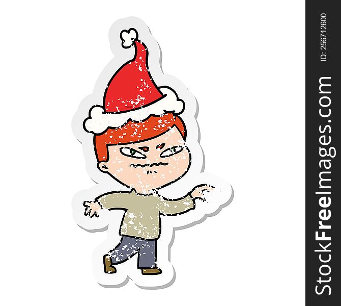 distressed sticker cartoon of a angry man pointing wearing santa hat