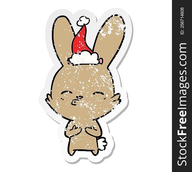 Curious Bunny Distressed Sticker Cartoon Of A Wearing Santa Hat