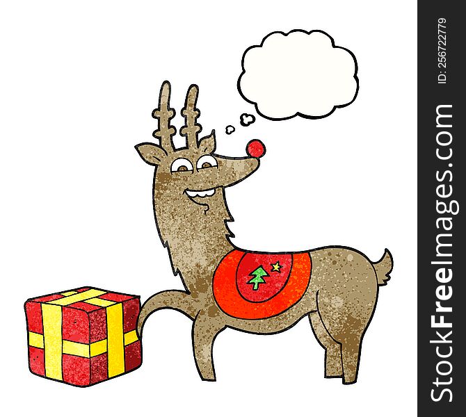 freehand drawn thought bubble textured cartoon christmas reindeer with present