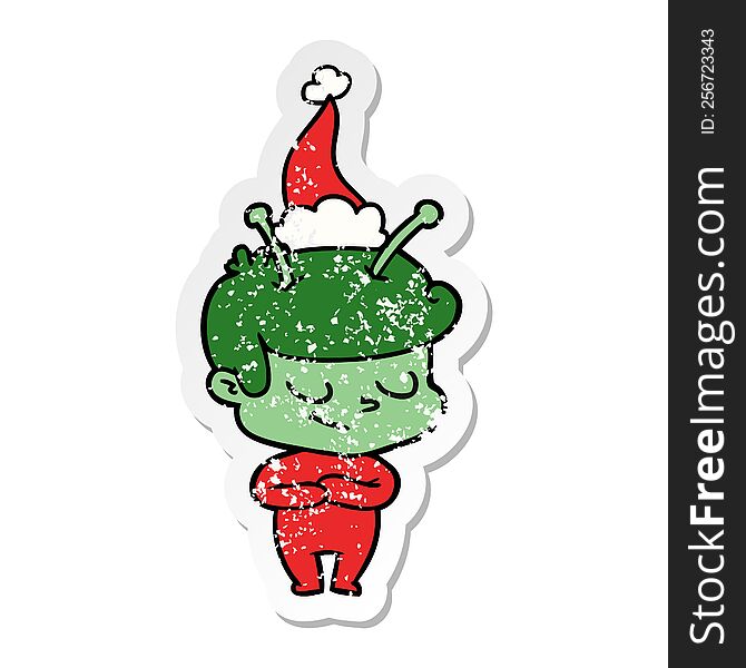 Friendly Distressed Sticker Cartoon Of A Spaceman Wearing Santa Hat