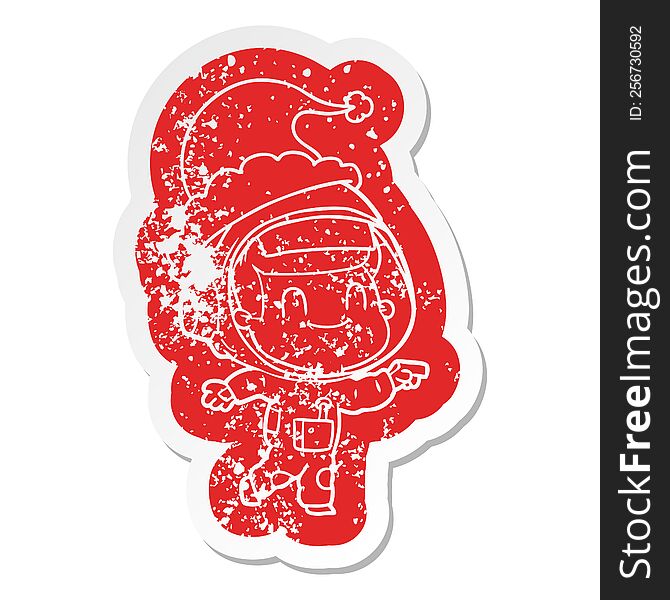 Happy Cartoon Distressed Sticker Of A Astronaut Man Wearing Santa Hat