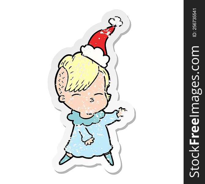 hand drawn distressed sticker cartoon of a squinting girl wearing santa hat