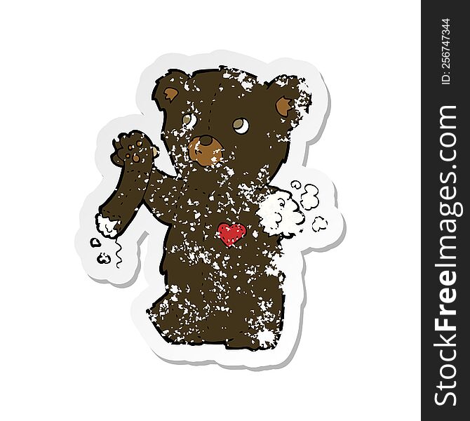 Retro Distressed Sticker Of A Cartoon Teddy Black Bear With Torn Arm