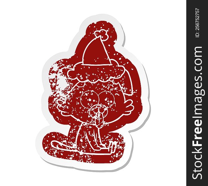 quirky cartoon distressed sticker of a sitting dog with tongue sticking out wearing santa hat