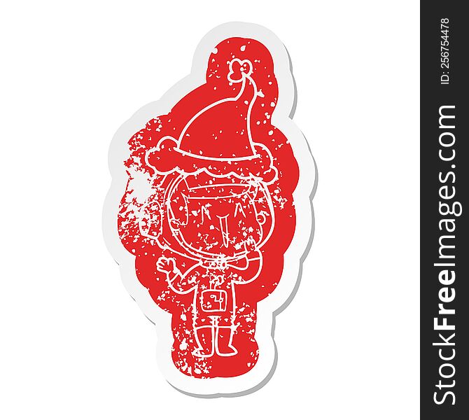 Laughing Cartoon Distressed Sticker Of A Astronaut Wearing Santa Hat