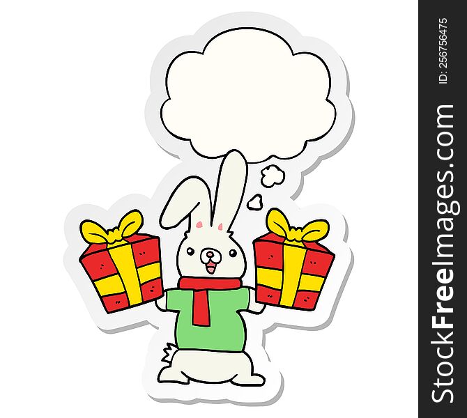 cartoon rabbit with christmas presents with thought bubble as a printed sticker