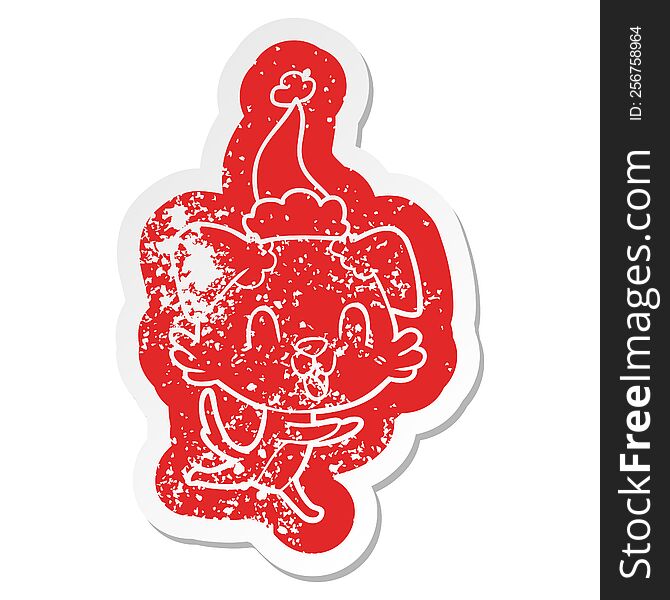 Laughing Cartoon Distressed Sticker Of A Dog Wearing Santa Hat