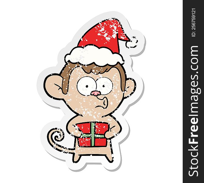Distressed Sticker Cartoon Of A Christmas Monkey Wearing Santa Hat