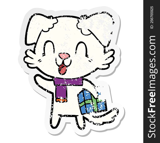 Distressed Sticker Of A Laughing Cartoon Dog With Christmas Present