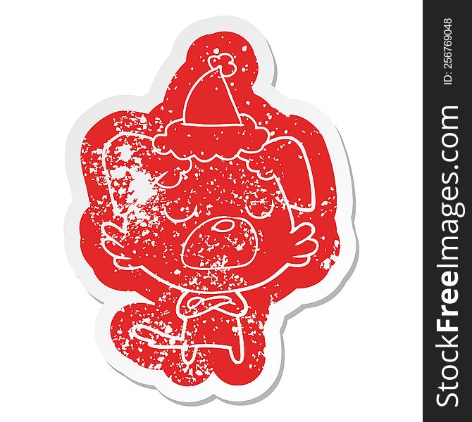 quirky cartoon distressed sticker of a dog wearing santa hat
