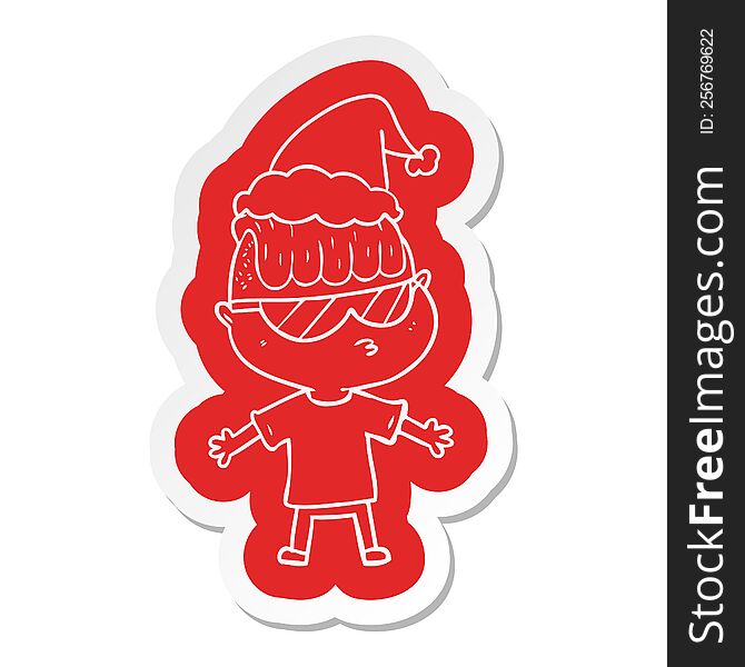 quirky cartoon  sticker of a boy wearing sunglasses wearing santa hat