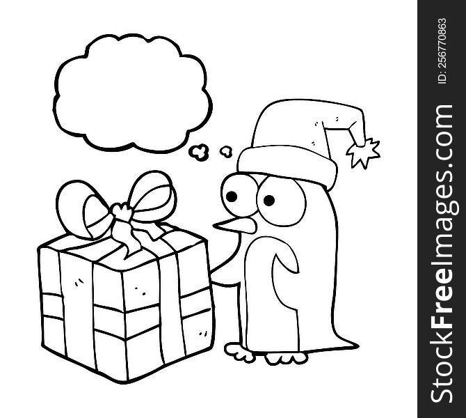 freehand drawn thought bubble cartoon christmas penguin with present