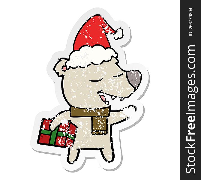 Distressed Sticker Cartoon Of A Bear With Present Wearing Santa Hat