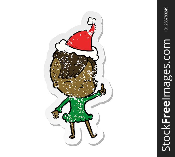 Distressed Sticker Cartoon Of A Squinting Girl Wearing Santa Hat