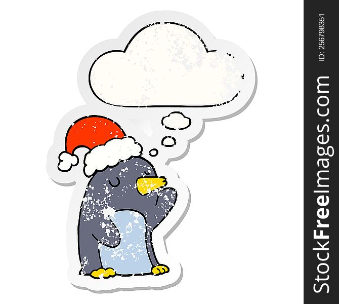 cute cartoon christmas penguin with thought bubble as a distressed worn sticker