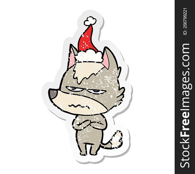 hand drawn distressed sticker cartoon of a annoyed wolf wearing santa hat