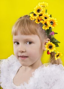 The Little Girl With Yellow Flowers In Hair. Stock Photo The Little Girl With Yellow Flowers In Hair. Stock Photo