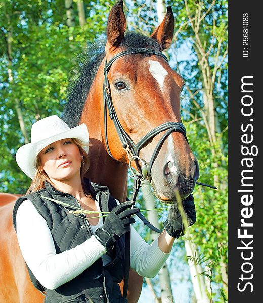 Women with her horse in park  at summer