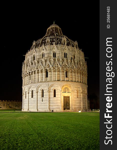 Night photo of the roman-style baptistery on the famous Piazza dei Miracoli in Piza, Italy. Night photo of the roman-style baptistery on the famous Piazza dei Miracoli in Piza, Italy