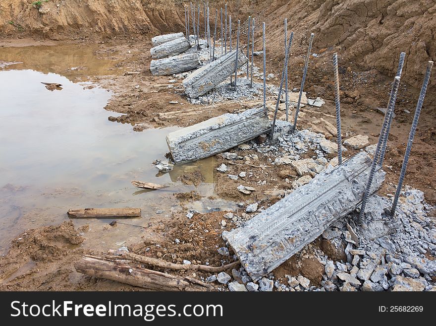 Breaking down concrete piles embedded into the soil to be prepared for a long iron rod. Breaking down concrete piles embedded into the soil to be prepared for a long iron rod.