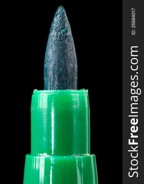 A close-up of a green felt tip pen on a black background. A close-up of a green felt tip pen on a black background